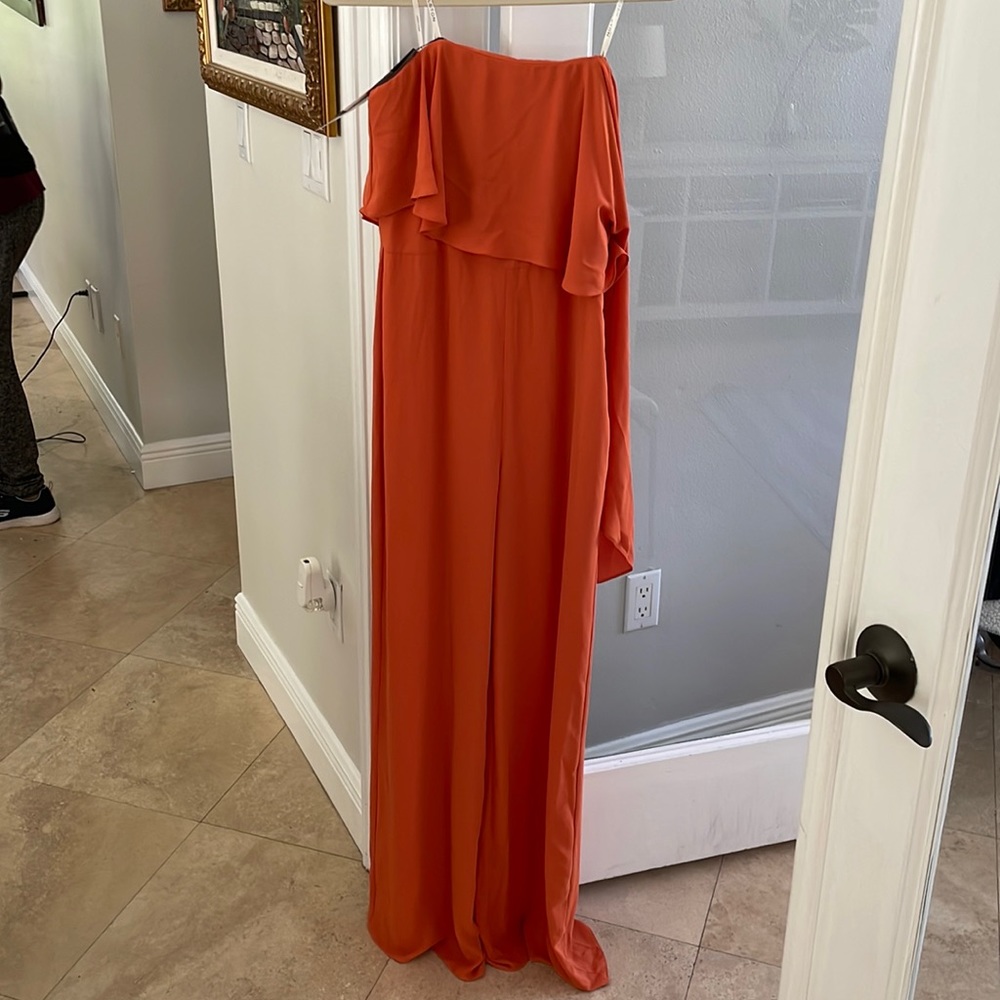 Orange Jumpsuit from Halston Heritage. It is a size 4 and has one arm opening.